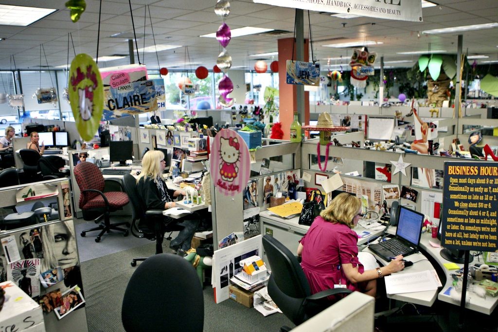 Workers sit at their desks in the couture department at the offices of internet retailer Zappos.com Inc.