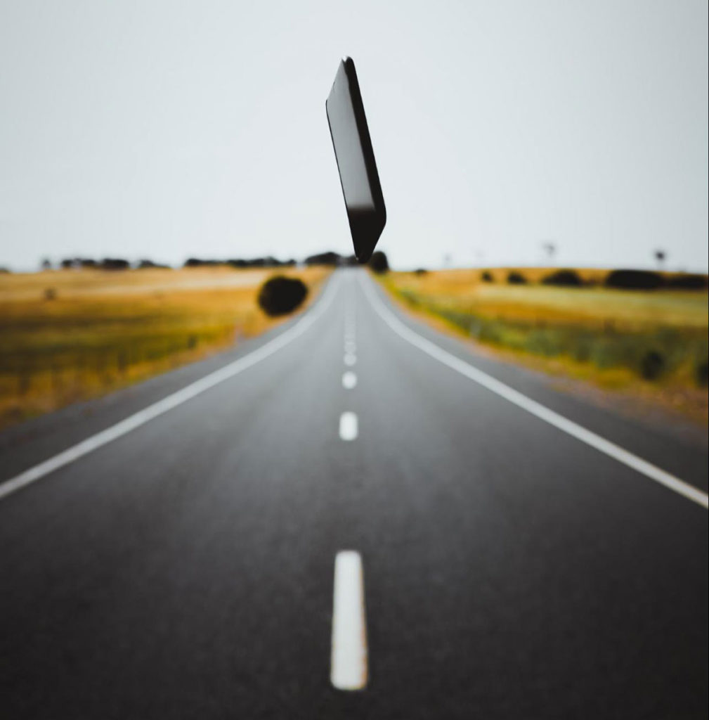 mobile phone suspended over a highway