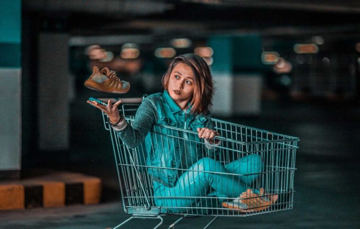 woman seating inside a grocery cart